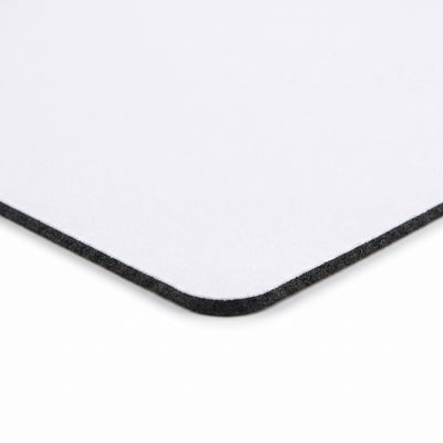 Close-up of the mouse pad corner, showing the fabric top and rubber base