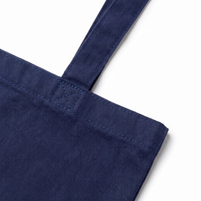 Calico navy blue tote bag, close-up of the self-fabric handle and reinforced stitching