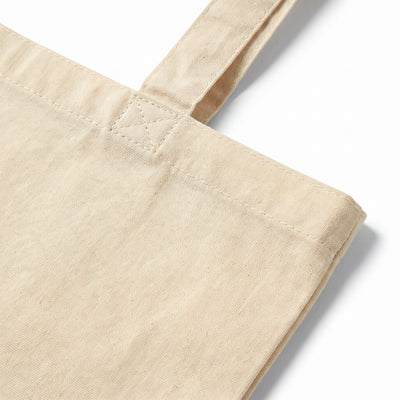 Calico sand tote bag, close-up of the self-fabric handle and reinforced stitching