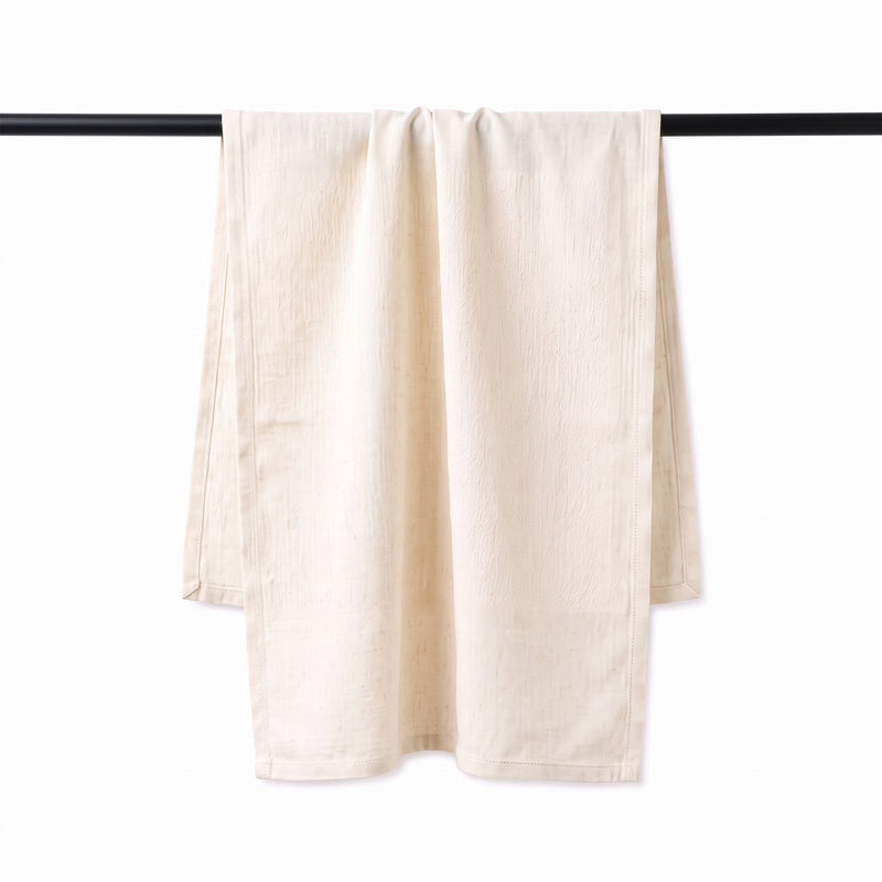 Natural linen blend tea towel hanging over a rail